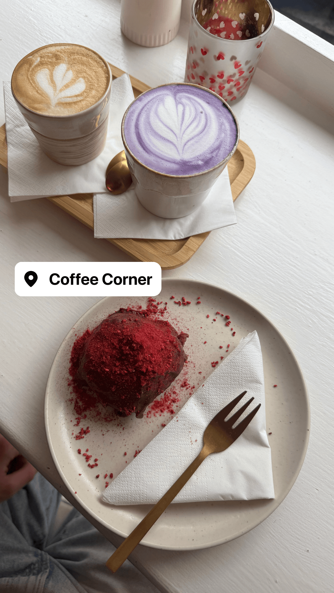 Latte art, a purple taro latte, and a red velvet pastry at Coffee Corner
