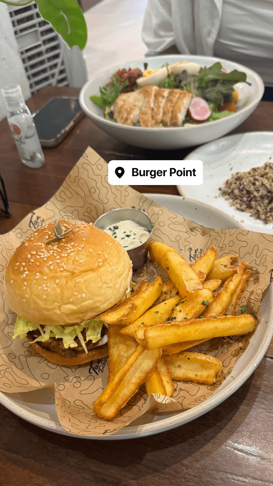 Burger with fries and a chicken salad bowl at Burger Point